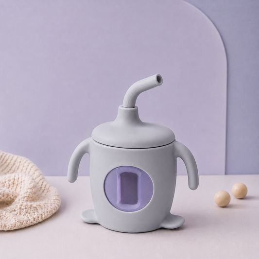 White baby sippy cup with a purple interior on a light blue background