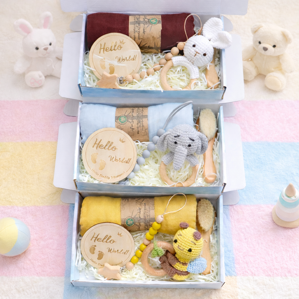 Baby gift set with toys and items in a box on a colorful blanket