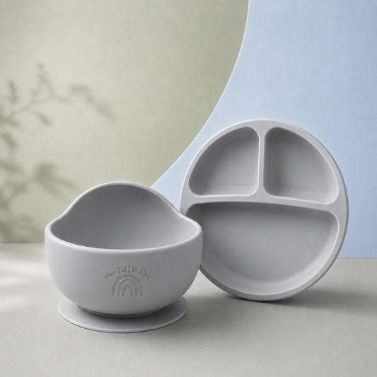 Gray silicone bowl and divided plate set on a neutral background