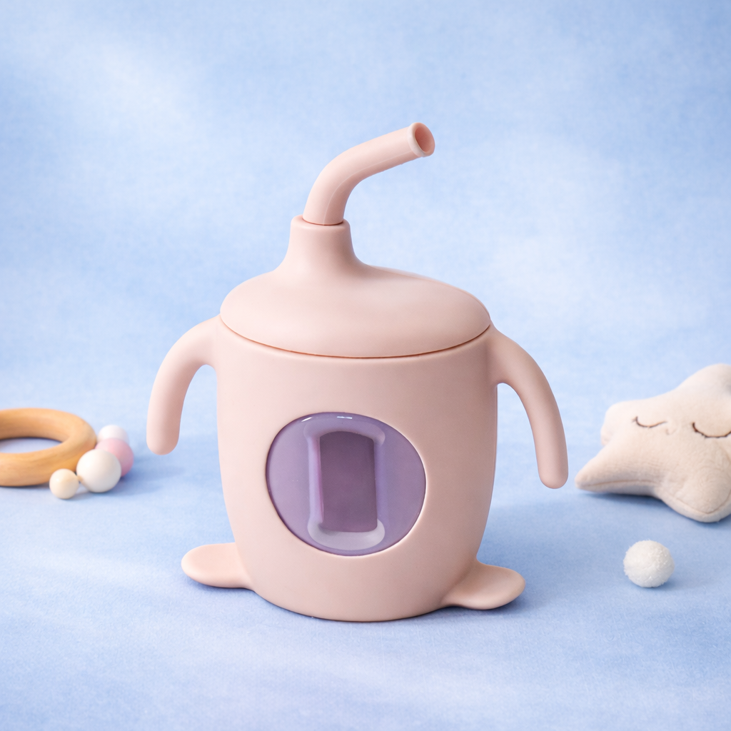 Pink sippy cup with a purple interior on a light blue background