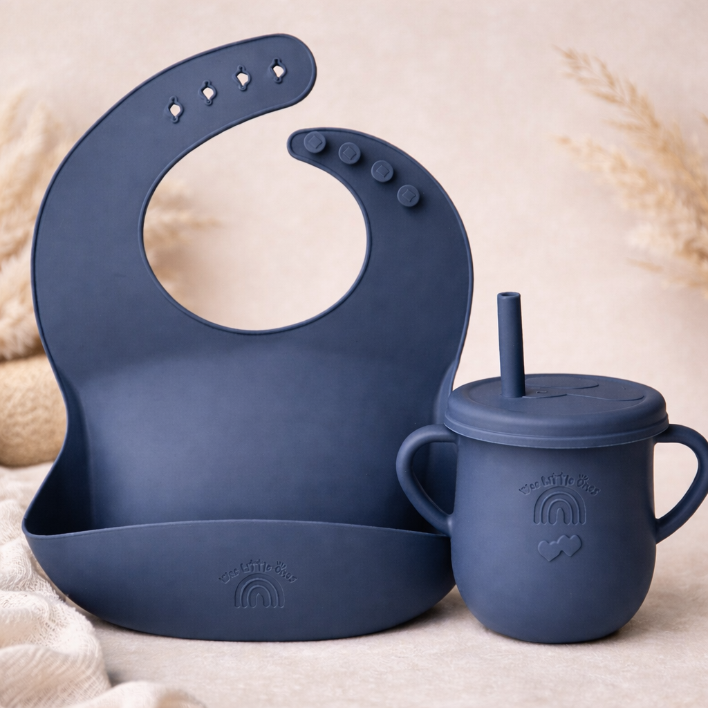 Navy blue silicone bib and sippy cup set on a beige background