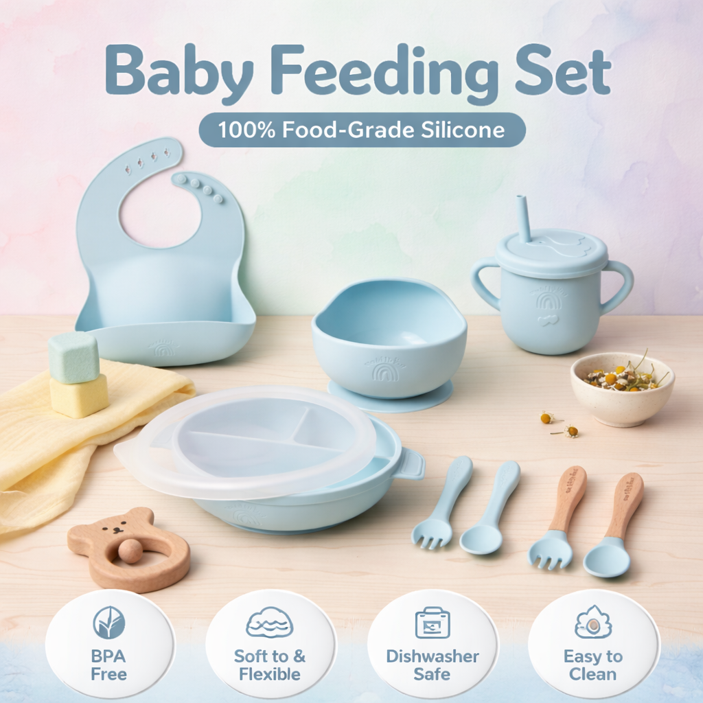 Baby feeding set with various utensils and a bib on a light background