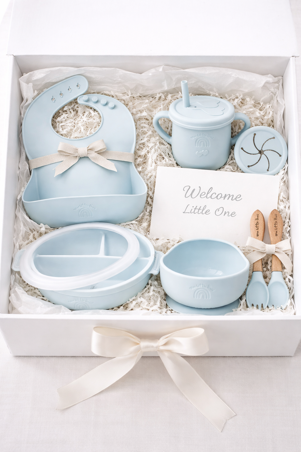 Baby gift set with blue baby items in a box on a white background