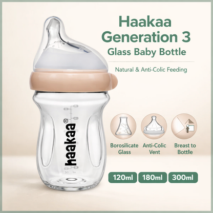 Haakaa Generation 3 glass baby bottle with beige cap on a light beige background