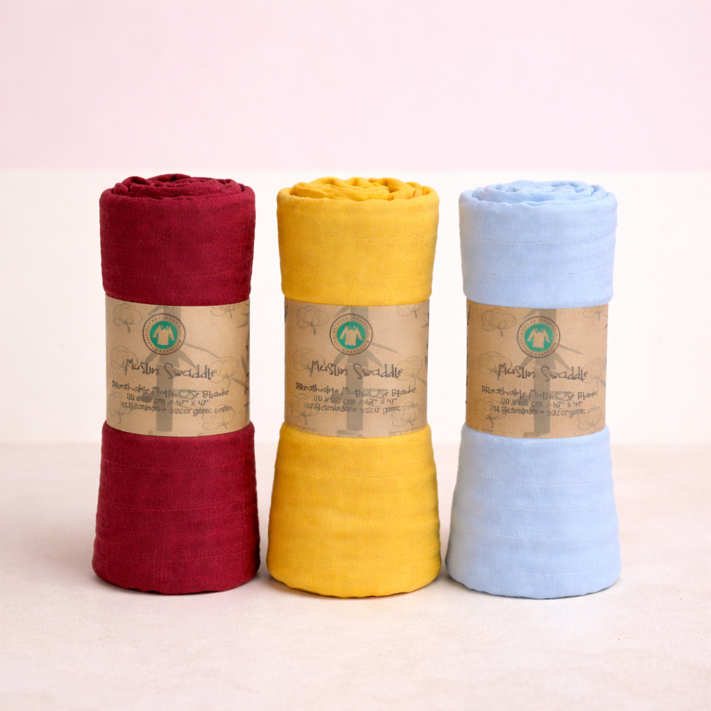 Three rolled-up cloths in red, yellow, and blue with visible branding on a light pink background.