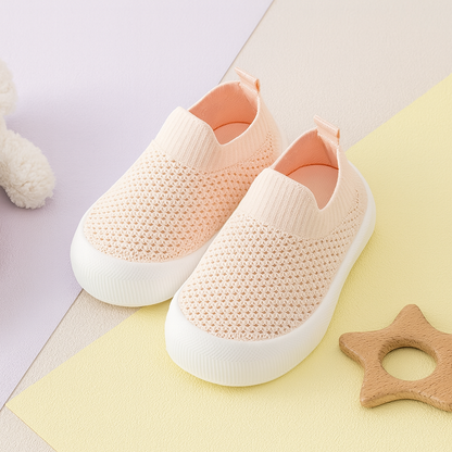 Pink breathable toddler shoes with soft white soles and slip-on design.