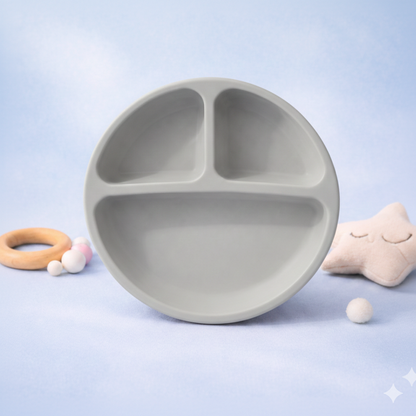 Gray children's plate with three sections on a light blue background