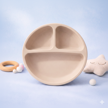 Beige children's plate with compartments on a light blue background