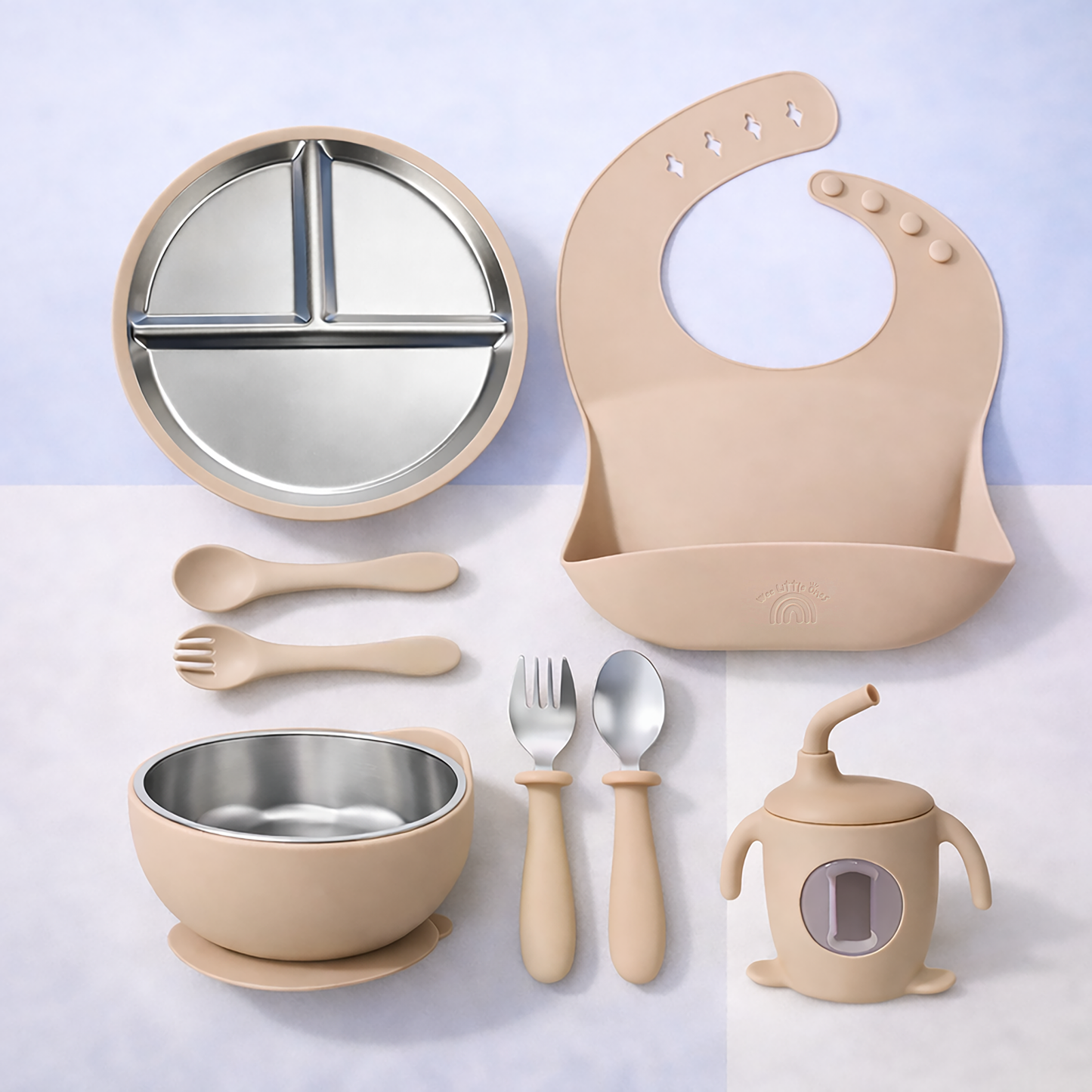 Beige baby dinner set with plate, bowl, spoon, fork, cup, and bib on a light gray background
