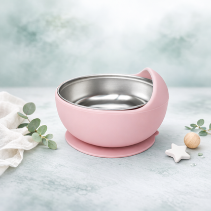 Pink baby bowl with a stainless steel interior on a light blue background