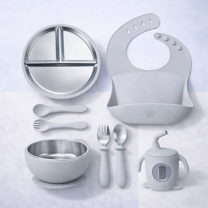 Collection of baby吃饭 and feeding utensils on a light gray background