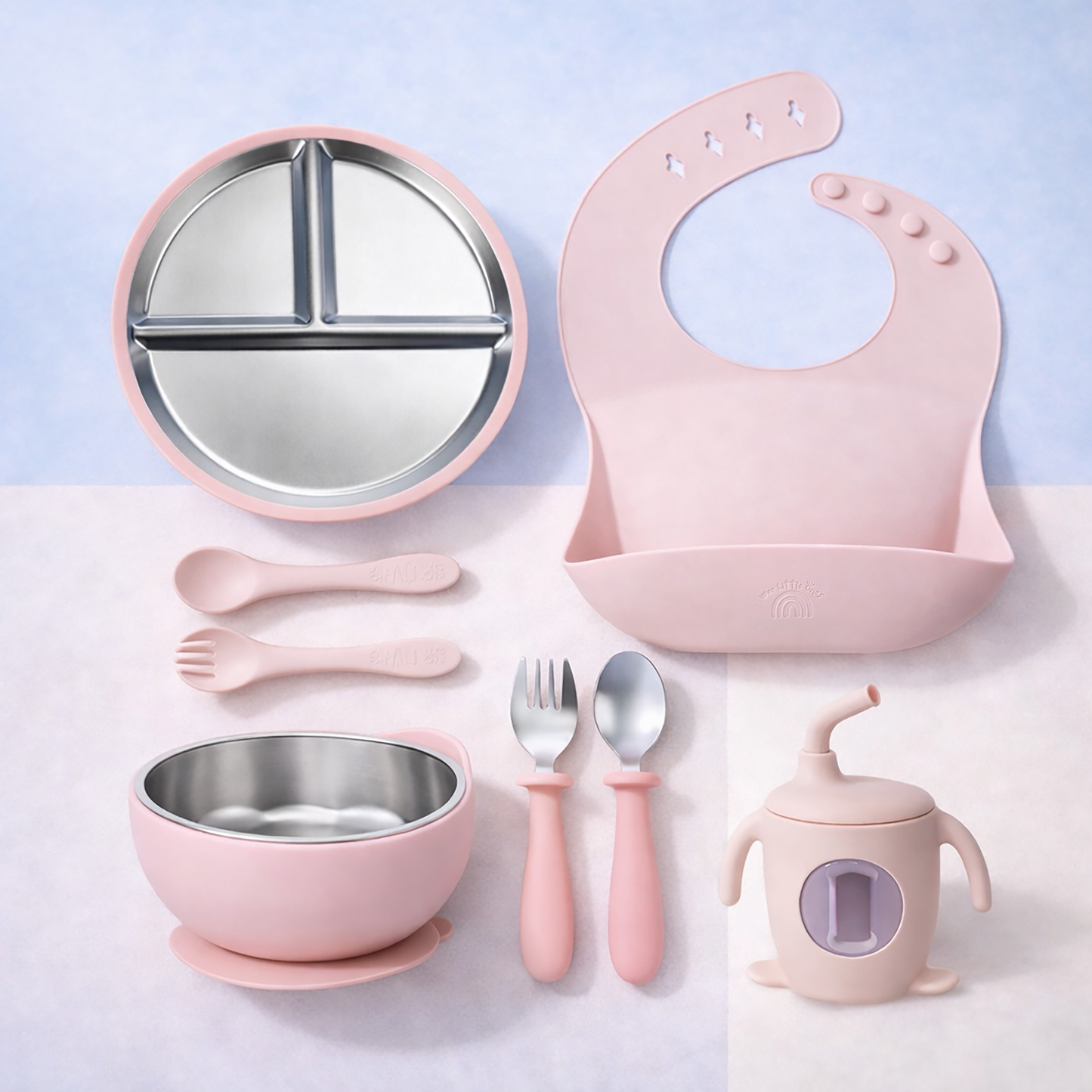 Pink baby dining set with bowl, cup, utensils, and bib on a light purple background