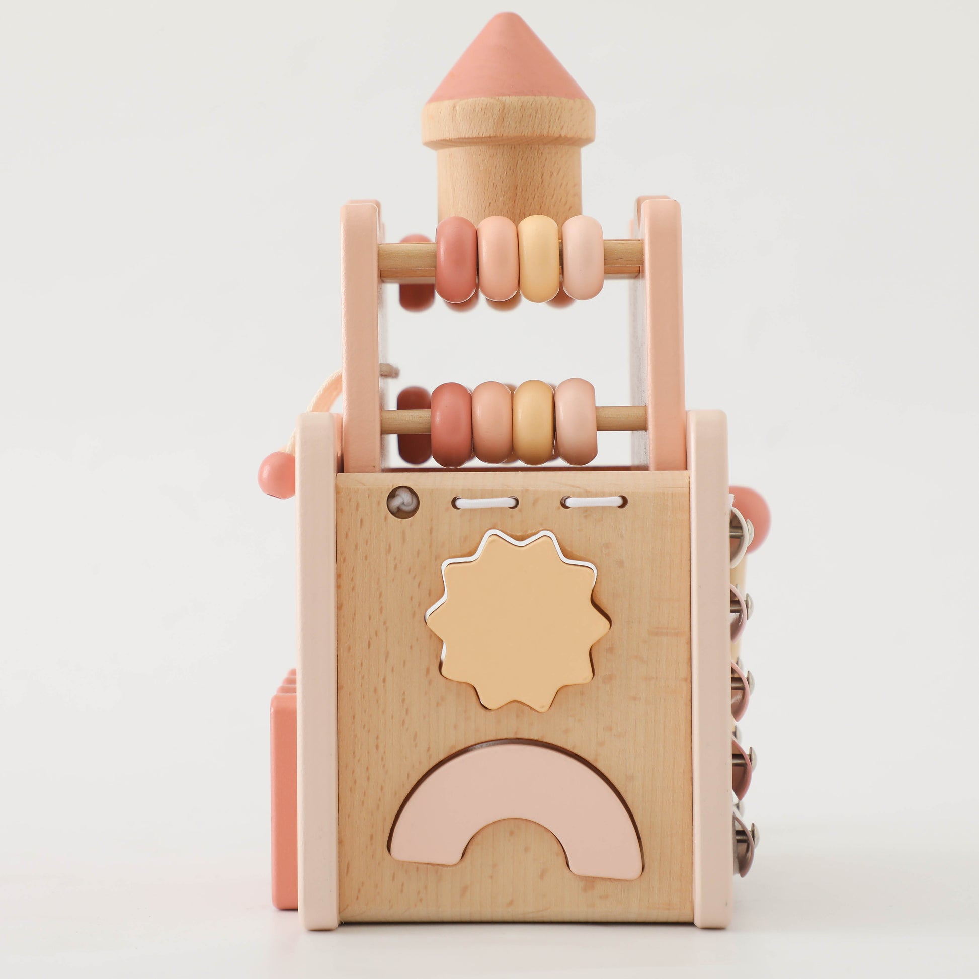 Wooden princess castle toy with pastel pink and natural wood beads and geometric shapes.