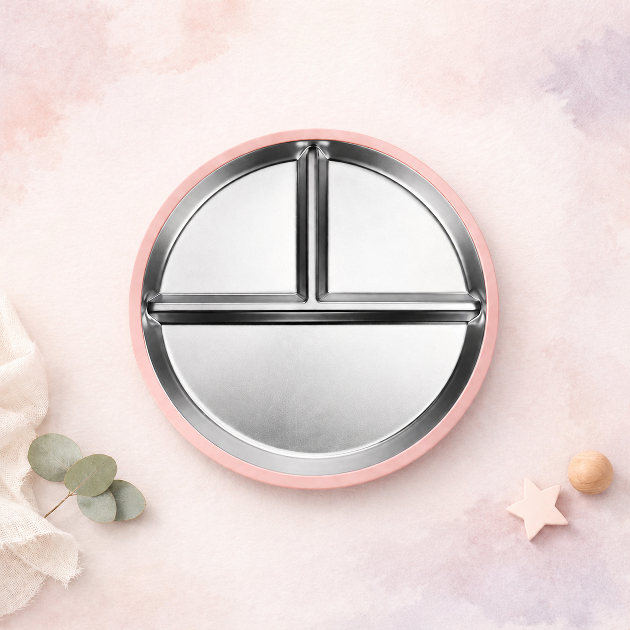 Round pink plate with silver分区 on a soft pink background